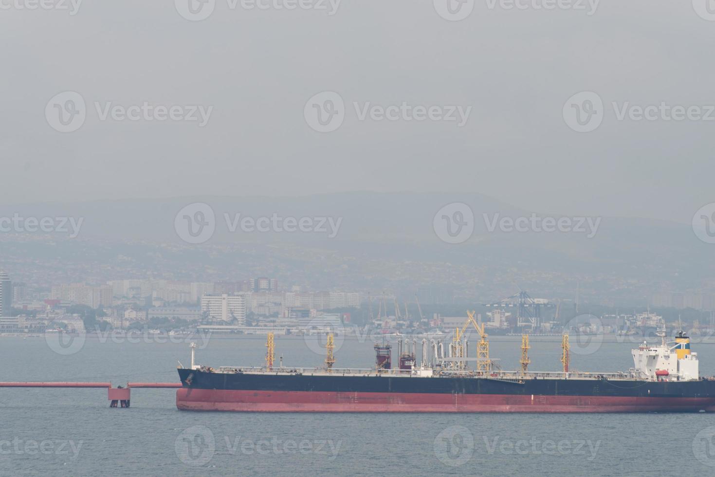 City view on a foggy summer day, large barge on the foreground photo