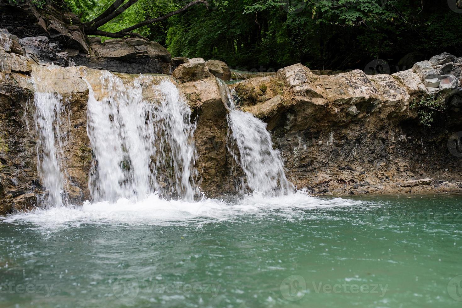 Beautiful tropical waterfall on rainy day photo