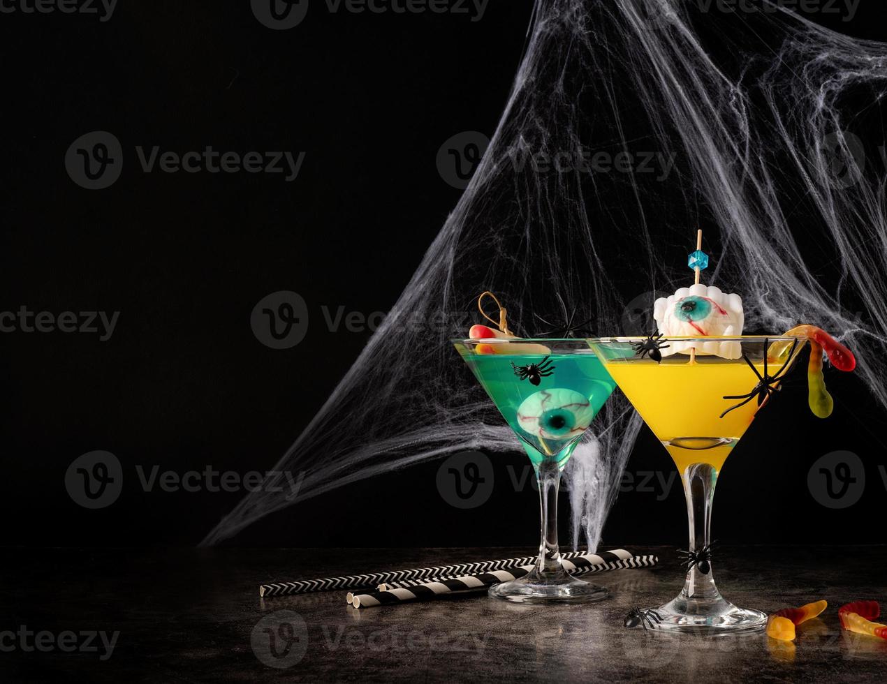 Scary colorful Halloween cocktails with party decorations on dark photo