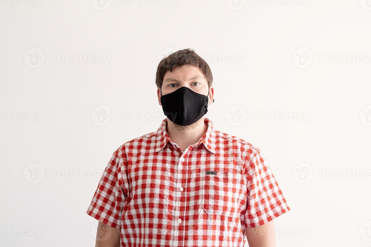 Young man putting on a protective mask photo