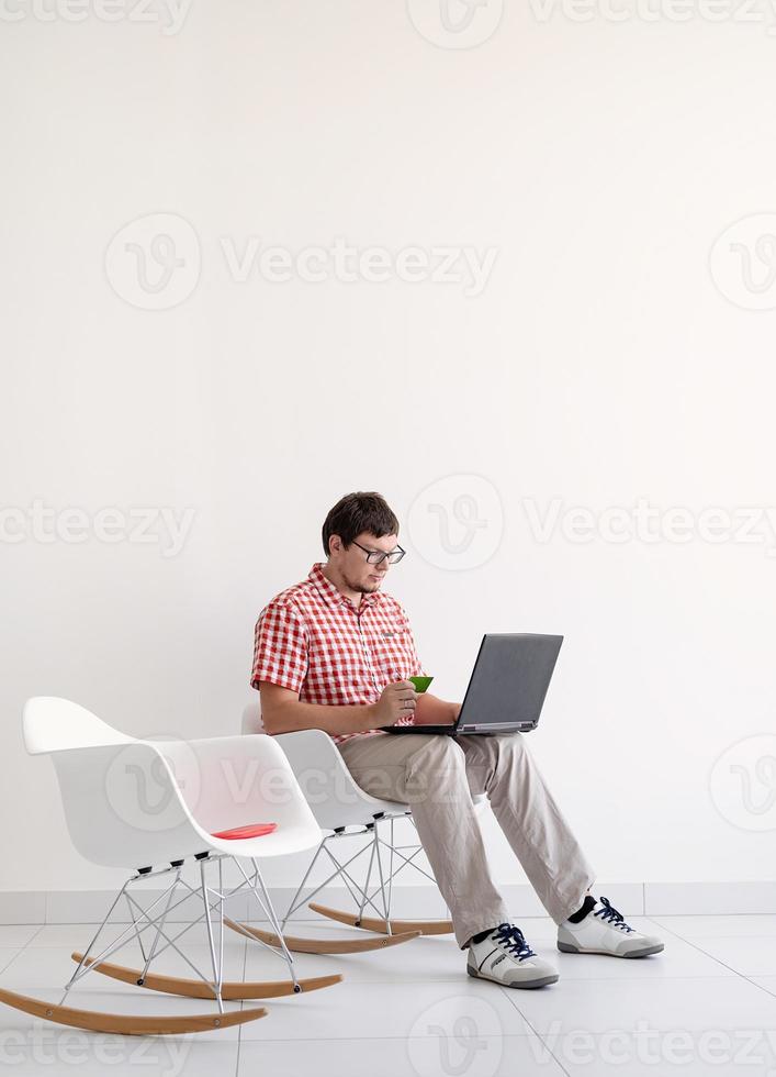 Young man shopping on internet with laptop photo