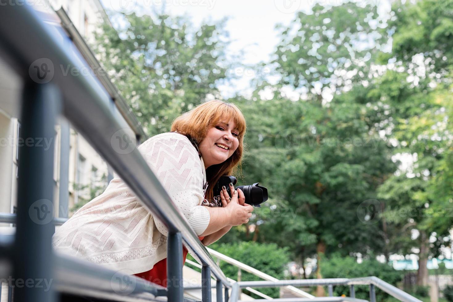 Plus size woman photographer outdoors photo