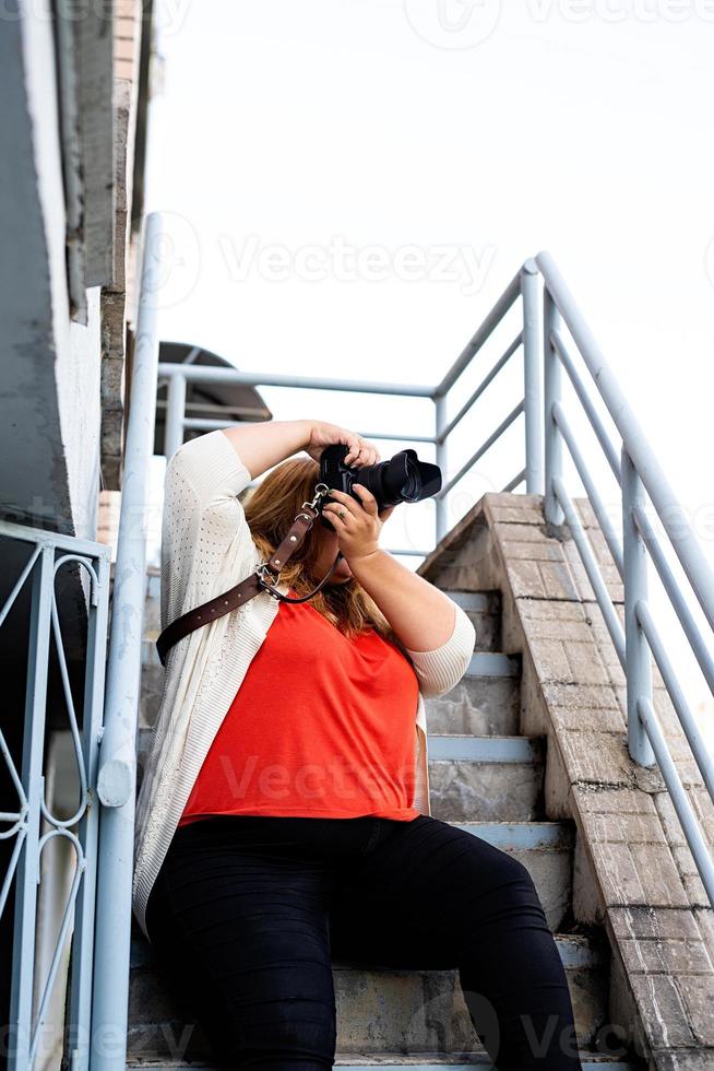 Plus size woman photographer outdoors photo