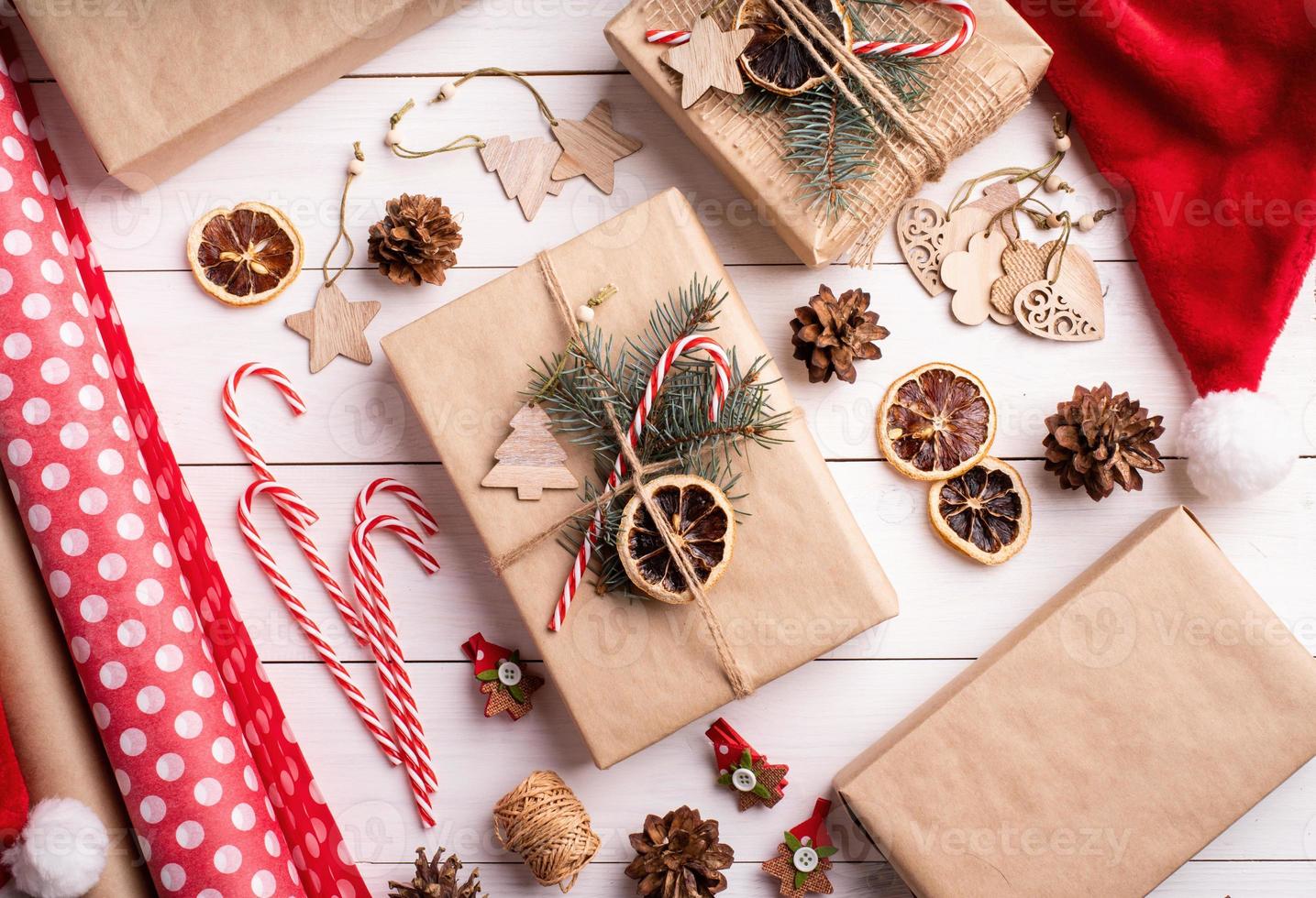 Gift boxes wrappaed in craft paper decorated with pine cones photo