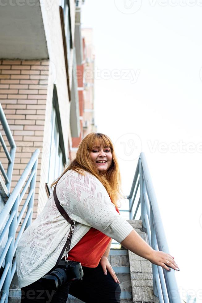 Plus size woman photographer outdoors photo