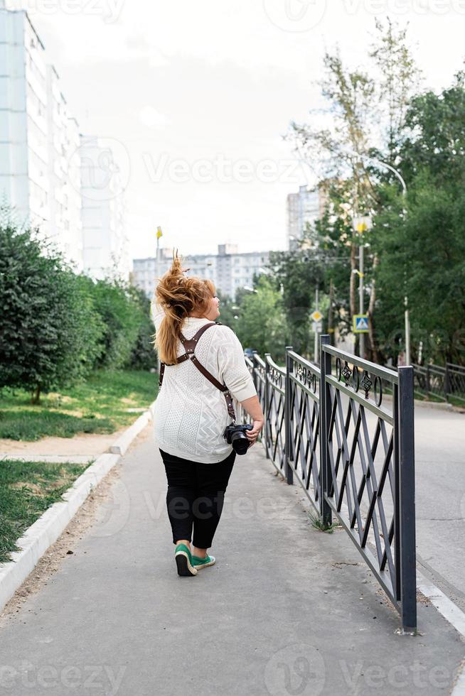 Plus size woman photographer outdoors photo