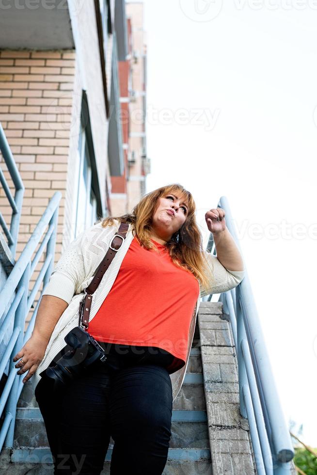 Plus size woman photographer outdoors photo