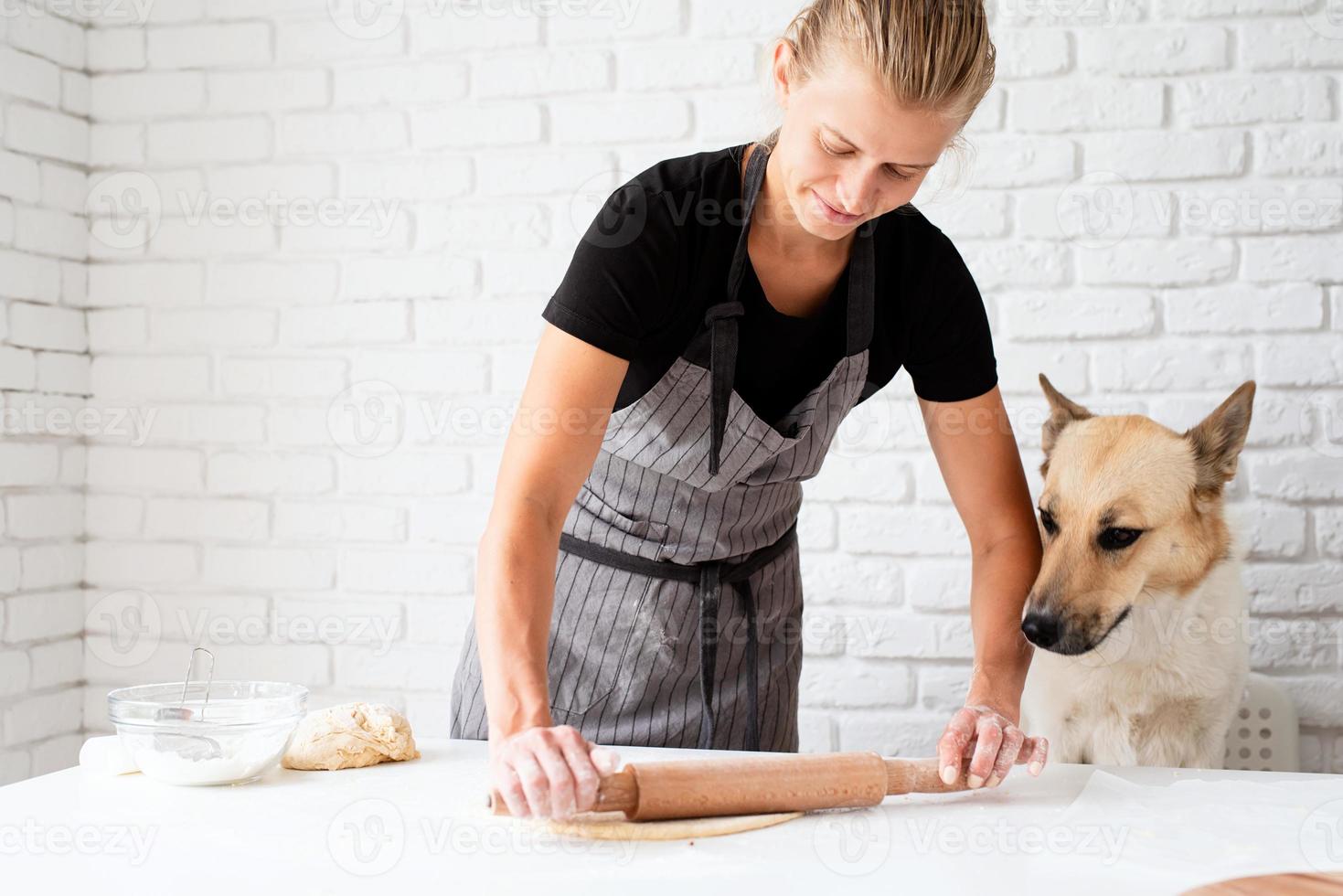 Woman kneading dough at home photo