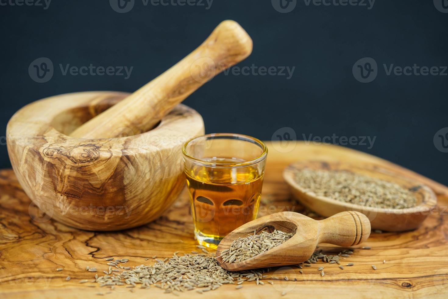 Cumin oil and olive wood photo