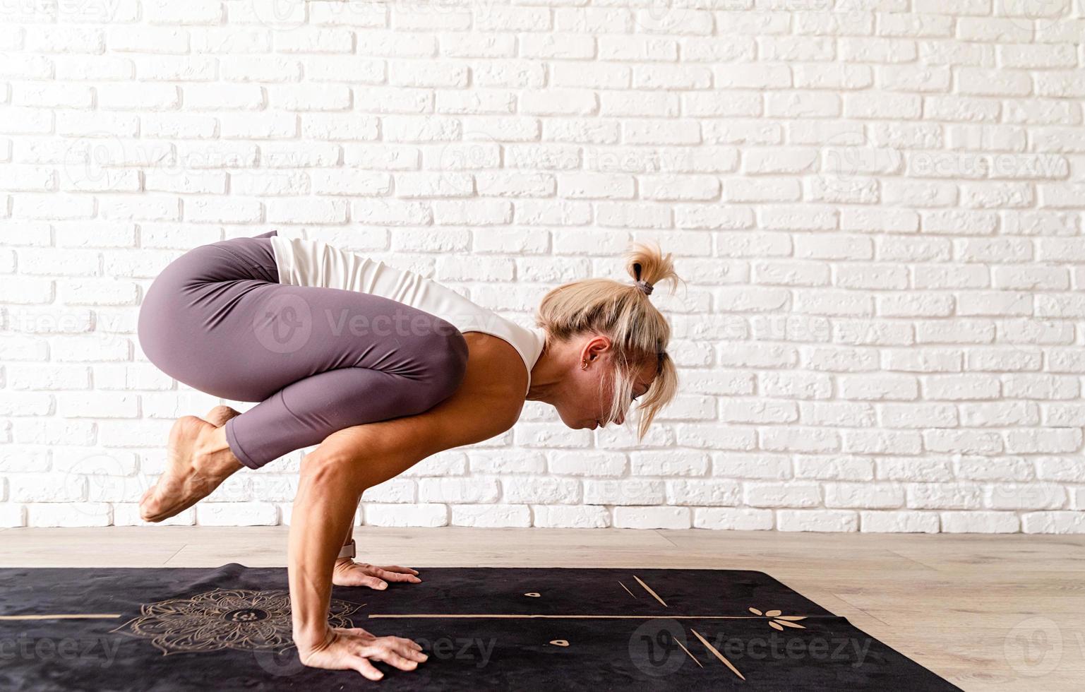 Young attractive woman practicing yoga, wearing sportswear photo