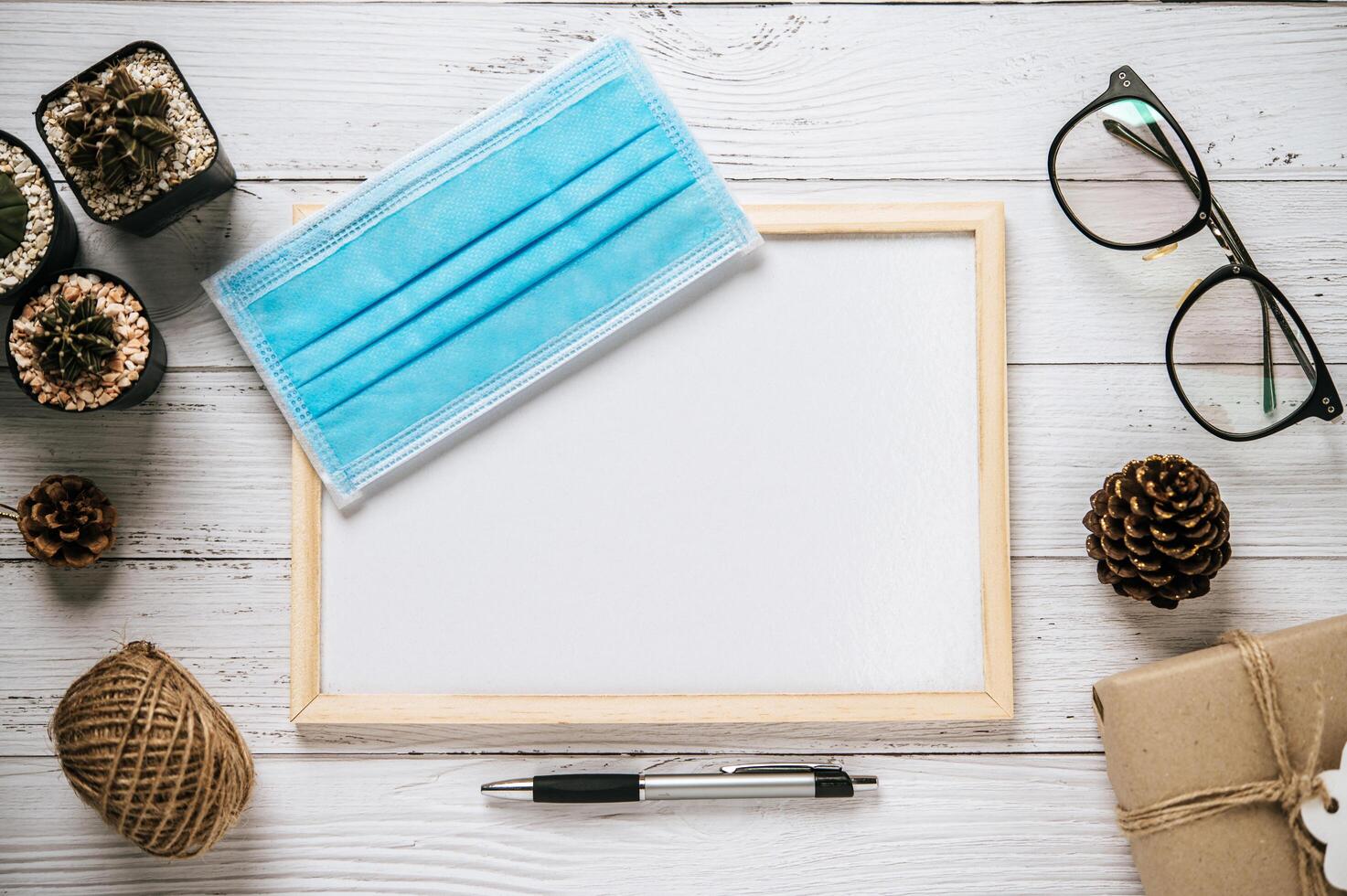 Mock up of flipchart and medical mask on wooden table photo