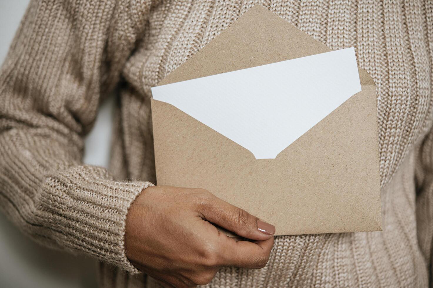 Hand holds an open card or letter photo