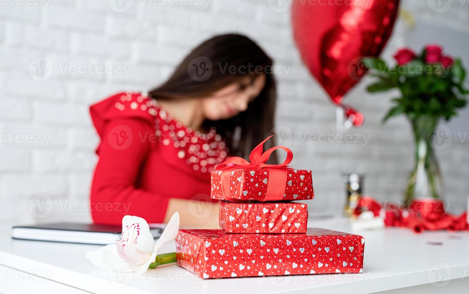 Woman holding small gift box with ribbon photo