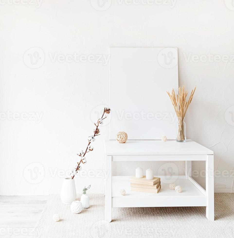 Mock up poster frame on table on white wall background photo