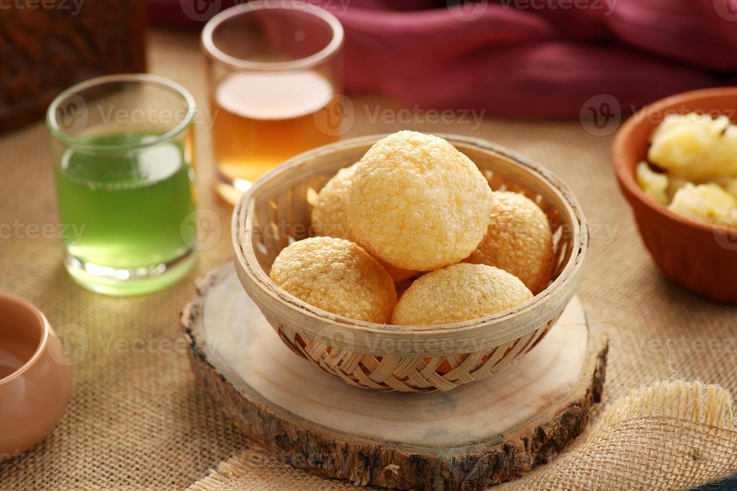 Indian Food Snacks Gol Gappe or Pani Puri or Puchka in a Wooden photo