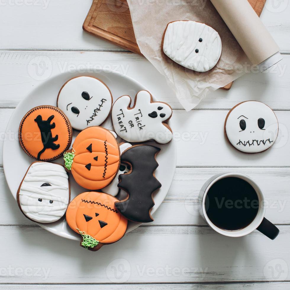 Preparation for Halloween. Coffee and scary gingerbread cookies. photo