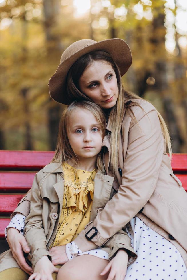 Mother and her daughter have fun and walk in the autumn park. photo