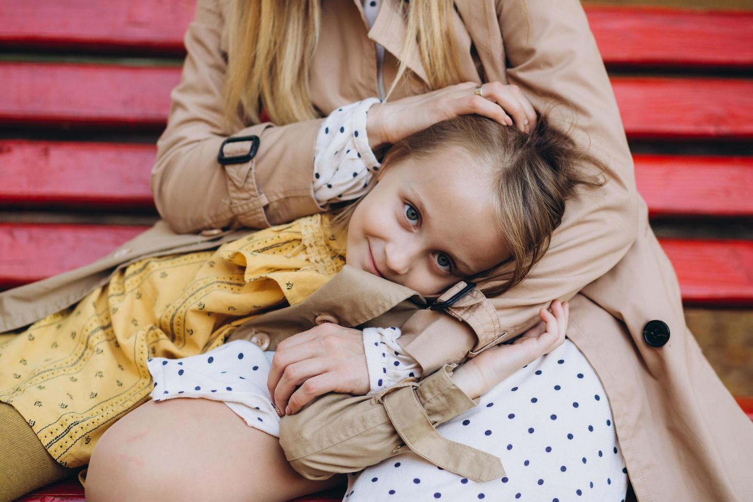 Mother and her daughter have fun and walk in the autumn park. photo