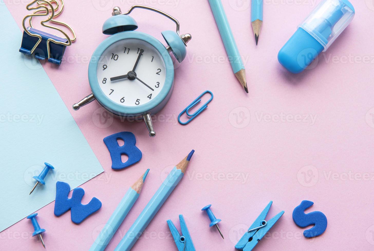 Frame of different stationery on pink background photo