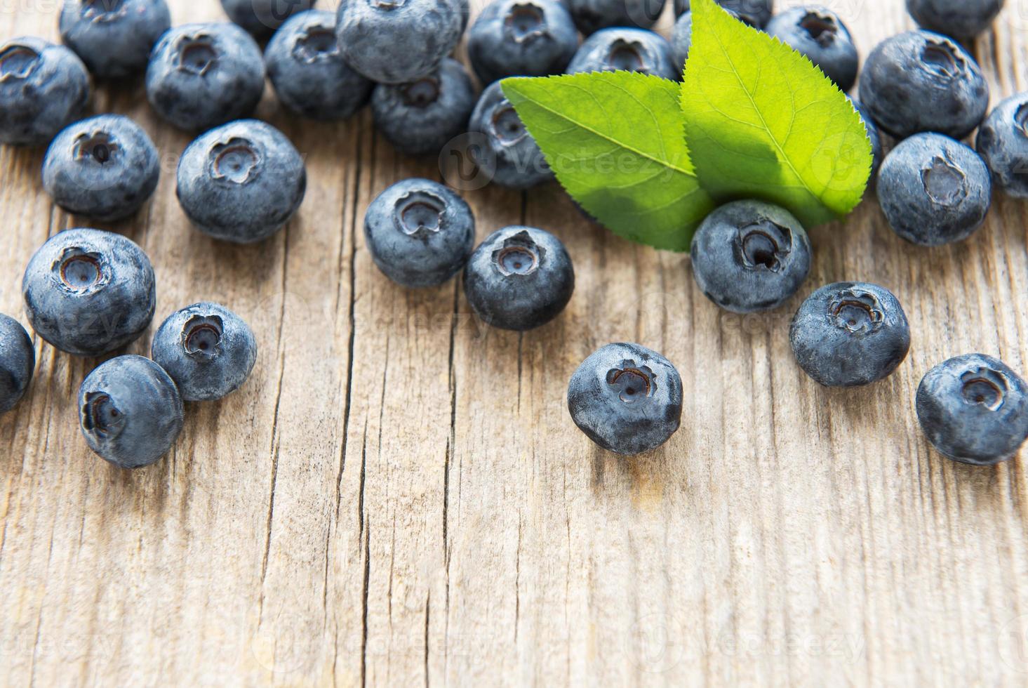 Blueberries on vintage wooden brown background photo