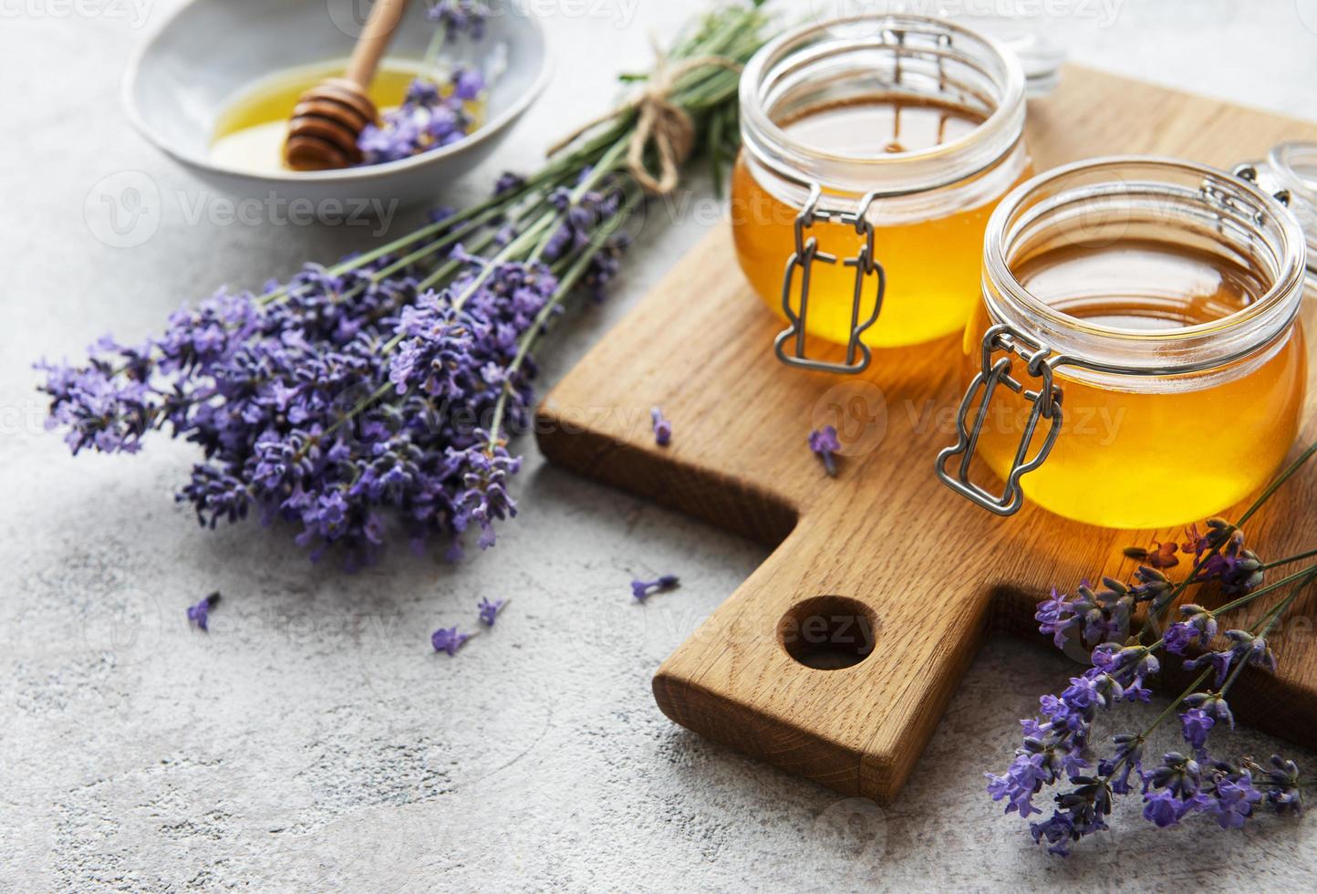 Jars with honey and fresh lavender flowers photo