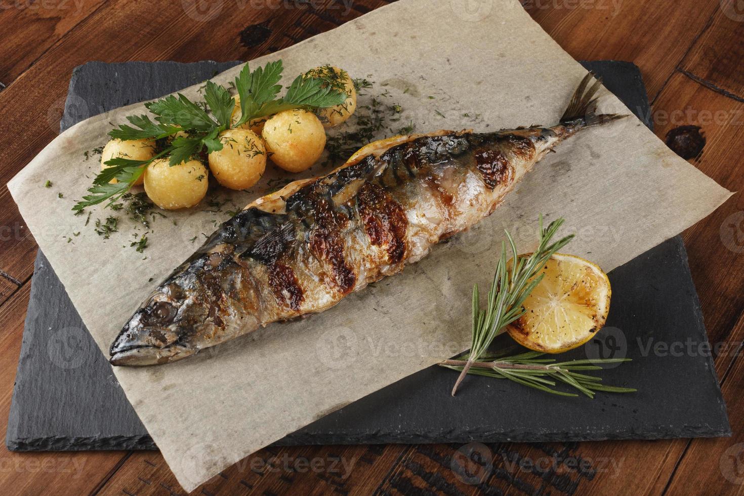 Fried mackerel fish stuffed with lemon. photo