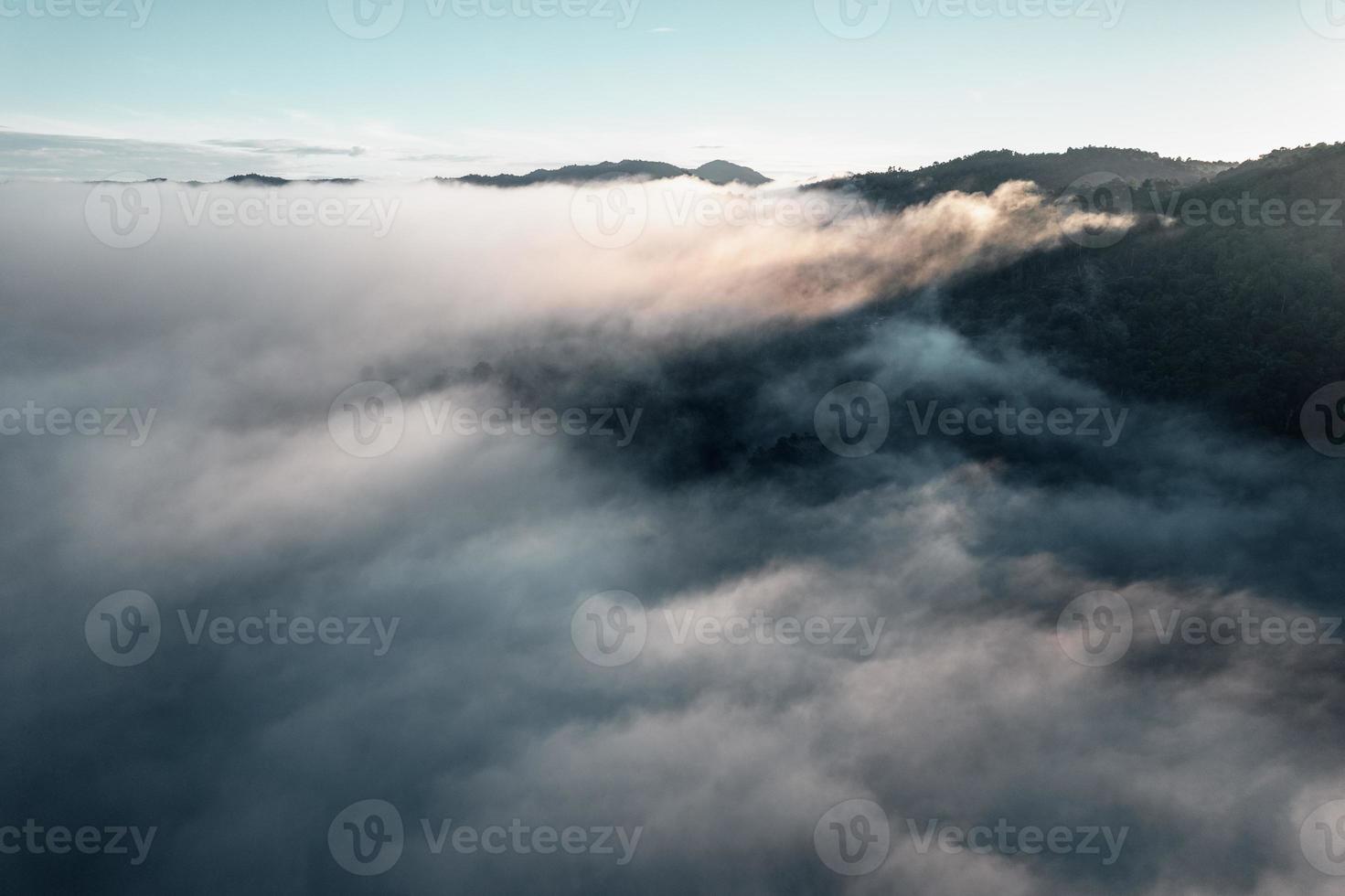 Morning fog in the mountains from above photo