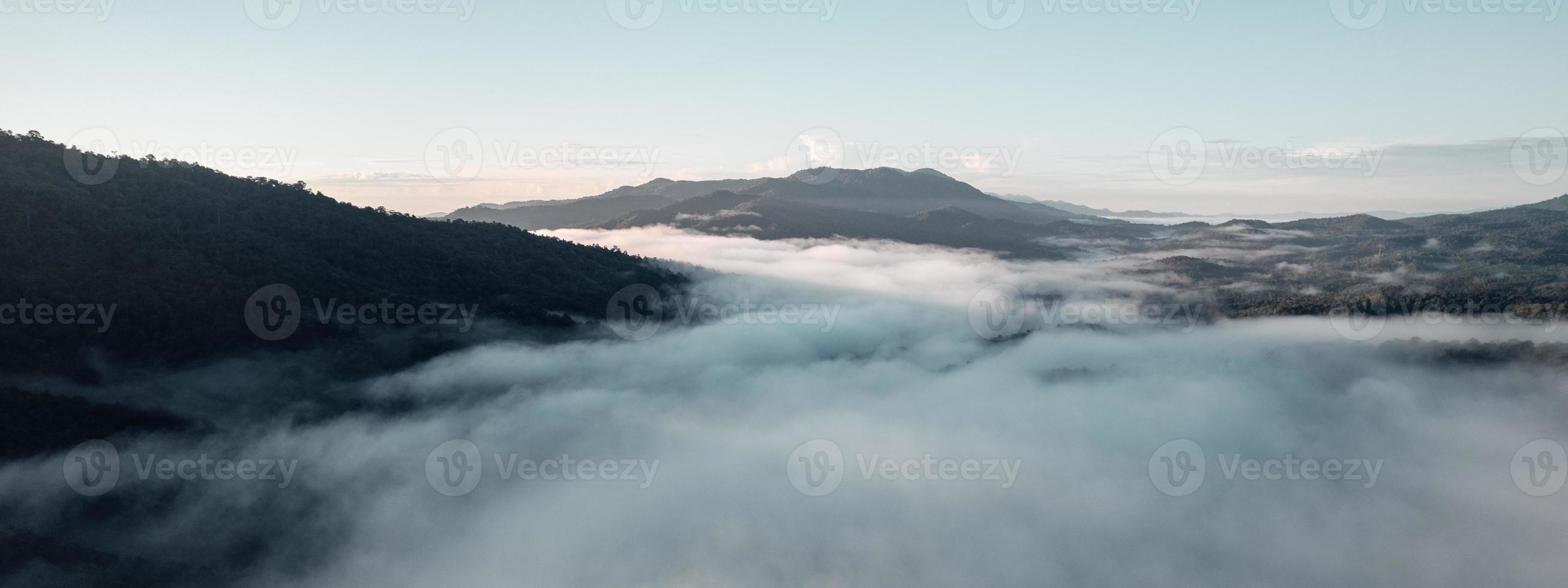 Morning fog in the mountains from above photo