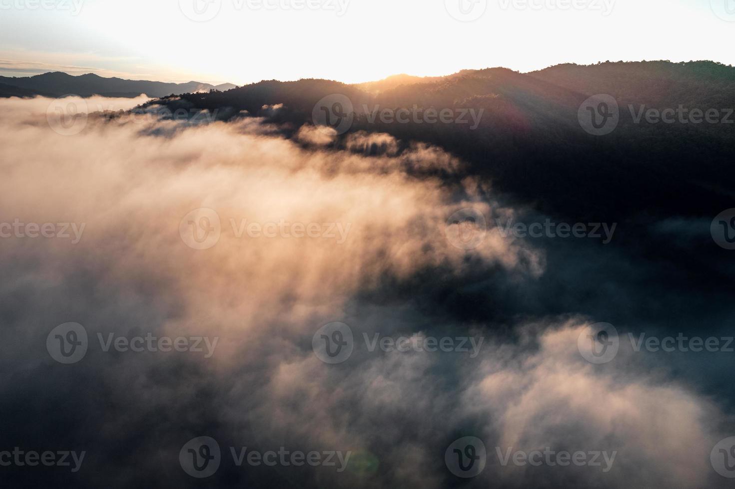 Morning fog in the mountains from above photo