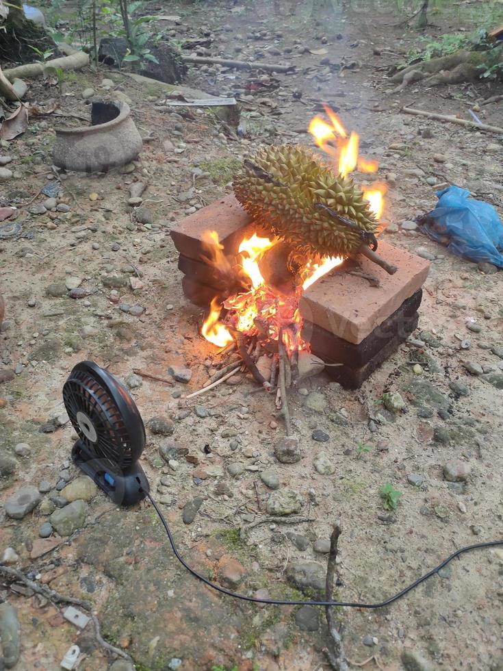 Select Focus, durian is placed over a charcoal stove that is heated to photo