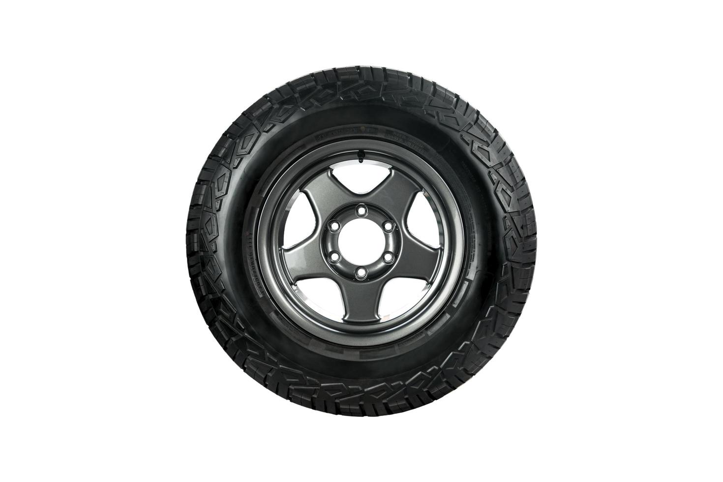 All terrain tire  with alloy wheel isolated on white background. photo