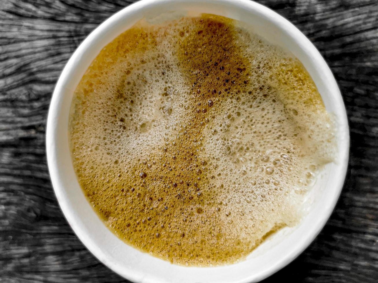 Paper cup coffee to go, wooden ground texture from above. photo