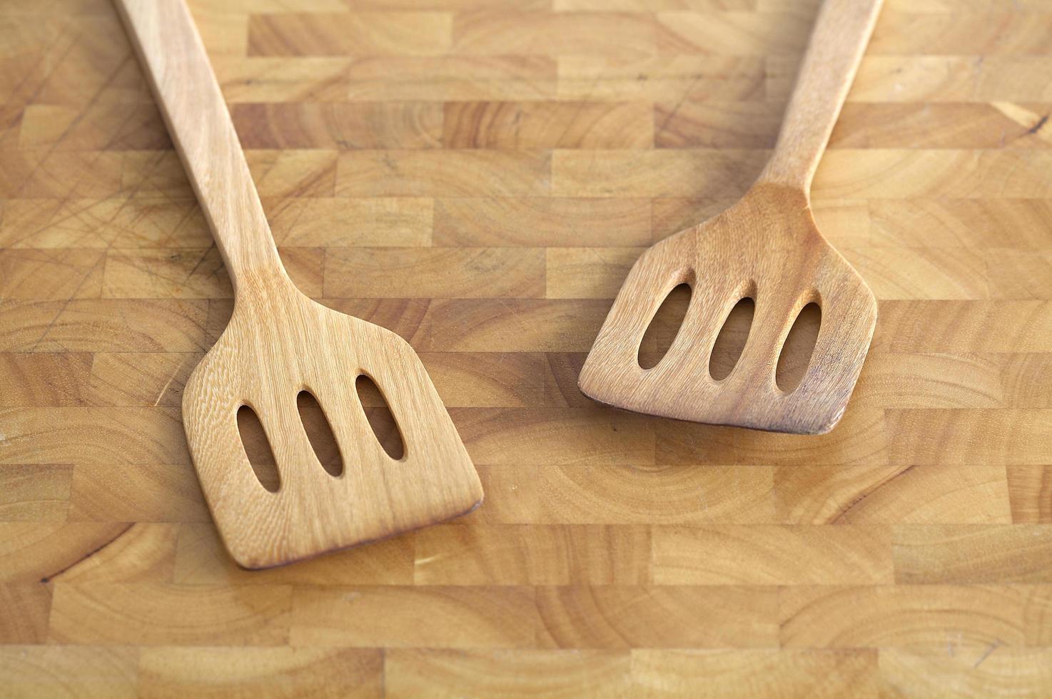 Wooden utensils on wooden table in natural light photo