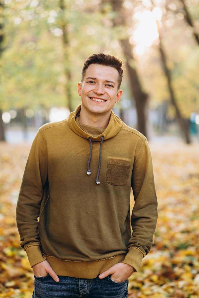 retrato, de, guapo, chico, sonriente, en, el, otoño, parque foto