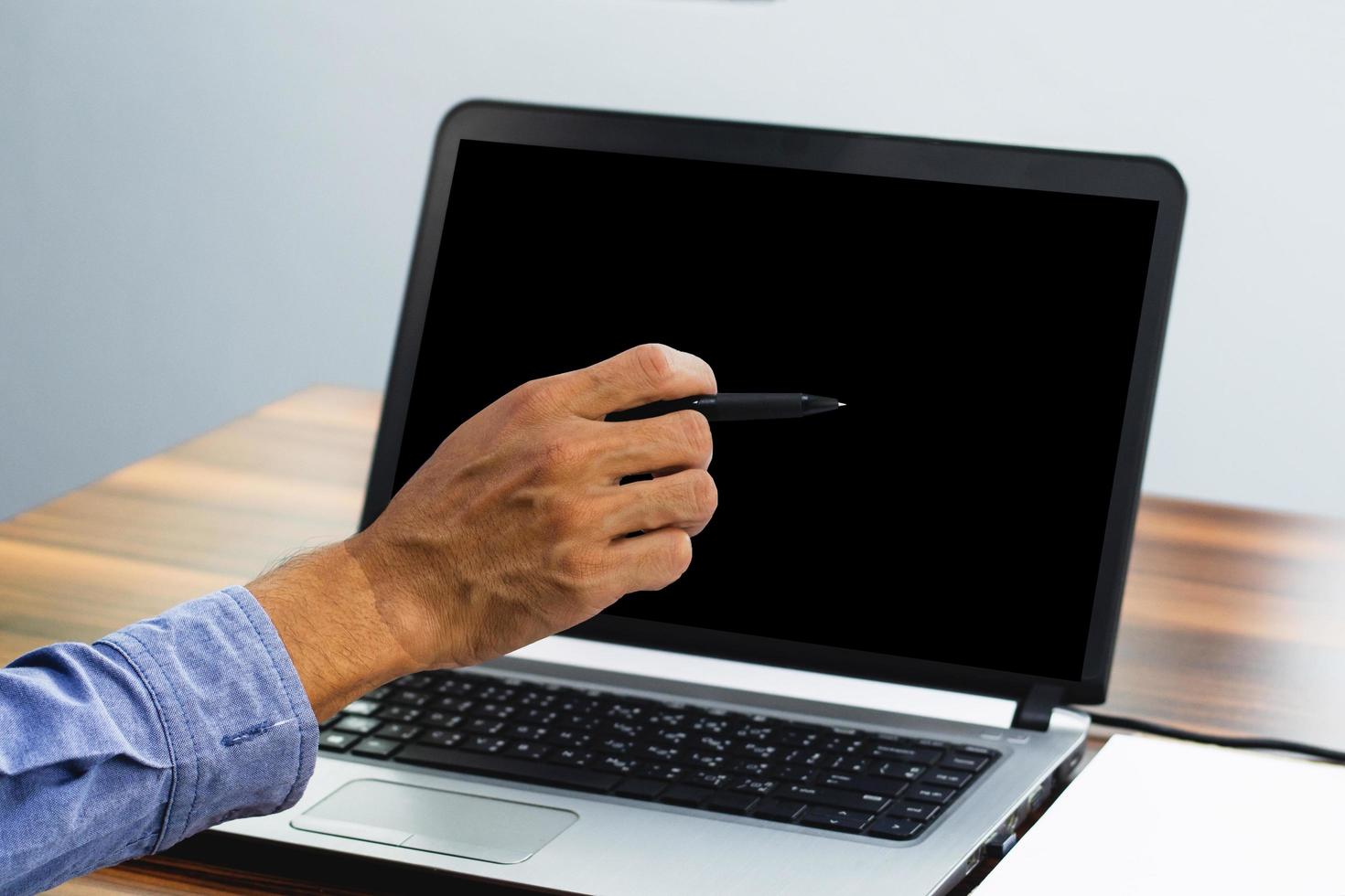 Hand pointing focus on computer in workspace office photo