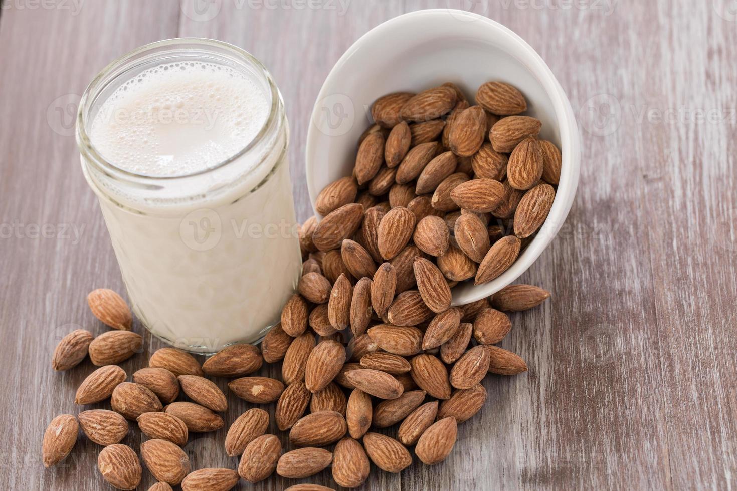 Almonds Spilling From White Bowl and Almond Milk photo