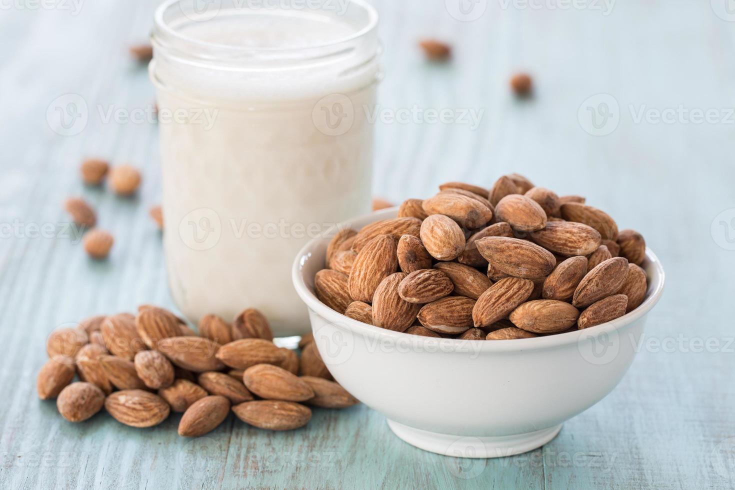 Almonds In White Bowl With Glass of Milk photo