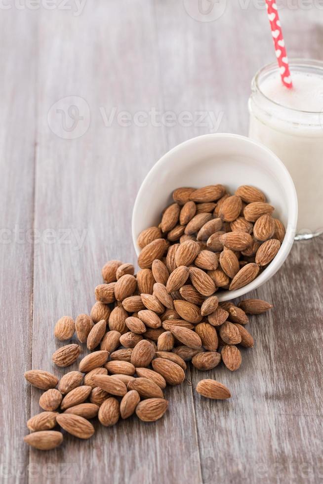 Almonds Spilling Out Of White Bowl photo