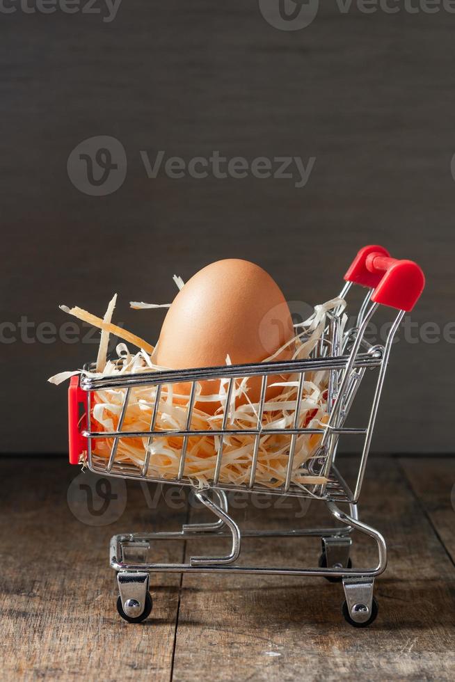 fresh Organic eggs with dry grass on the grocery shopping cart photo