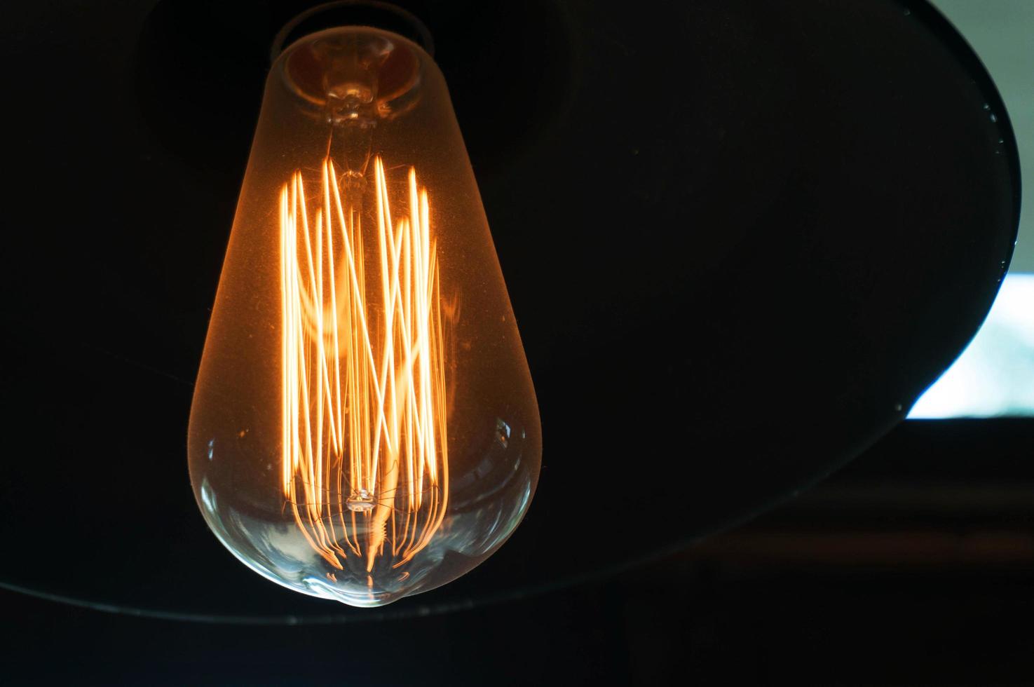 Decorative antique edison style light bulbs against black background photo