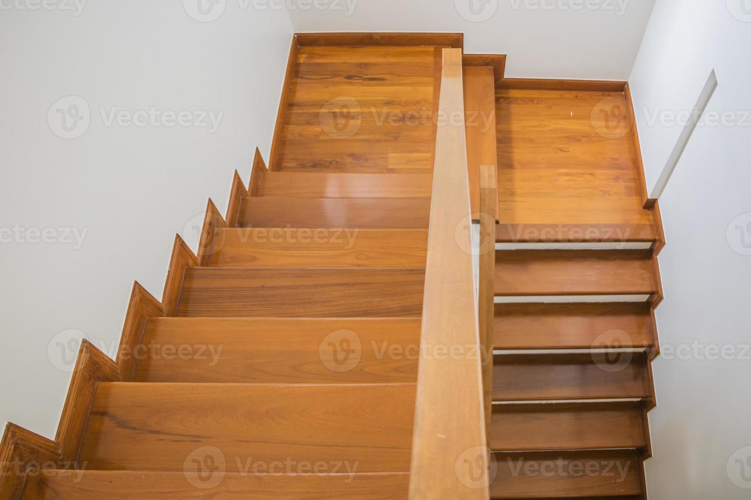 Staircase, wooden floor and black iron rail. photo