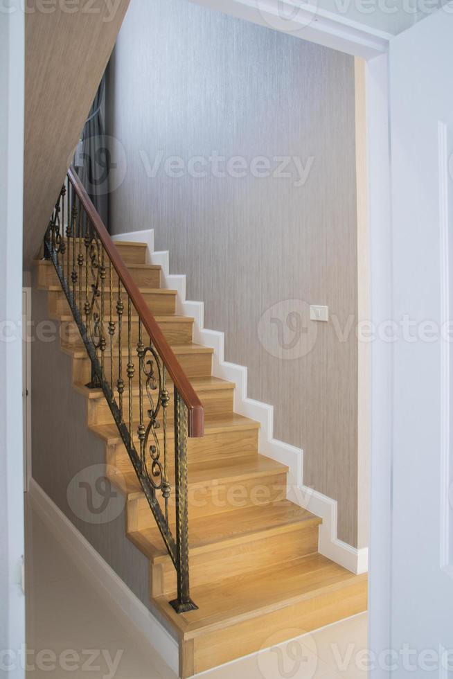 Staircase, wooden floor and black iron rail. photo