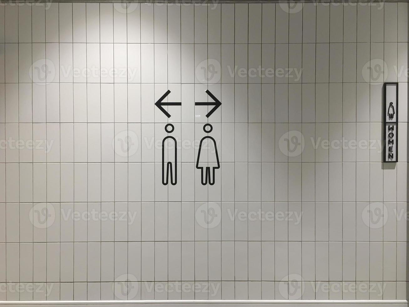 A sign that shows the way to the bathroom in a mall. photo