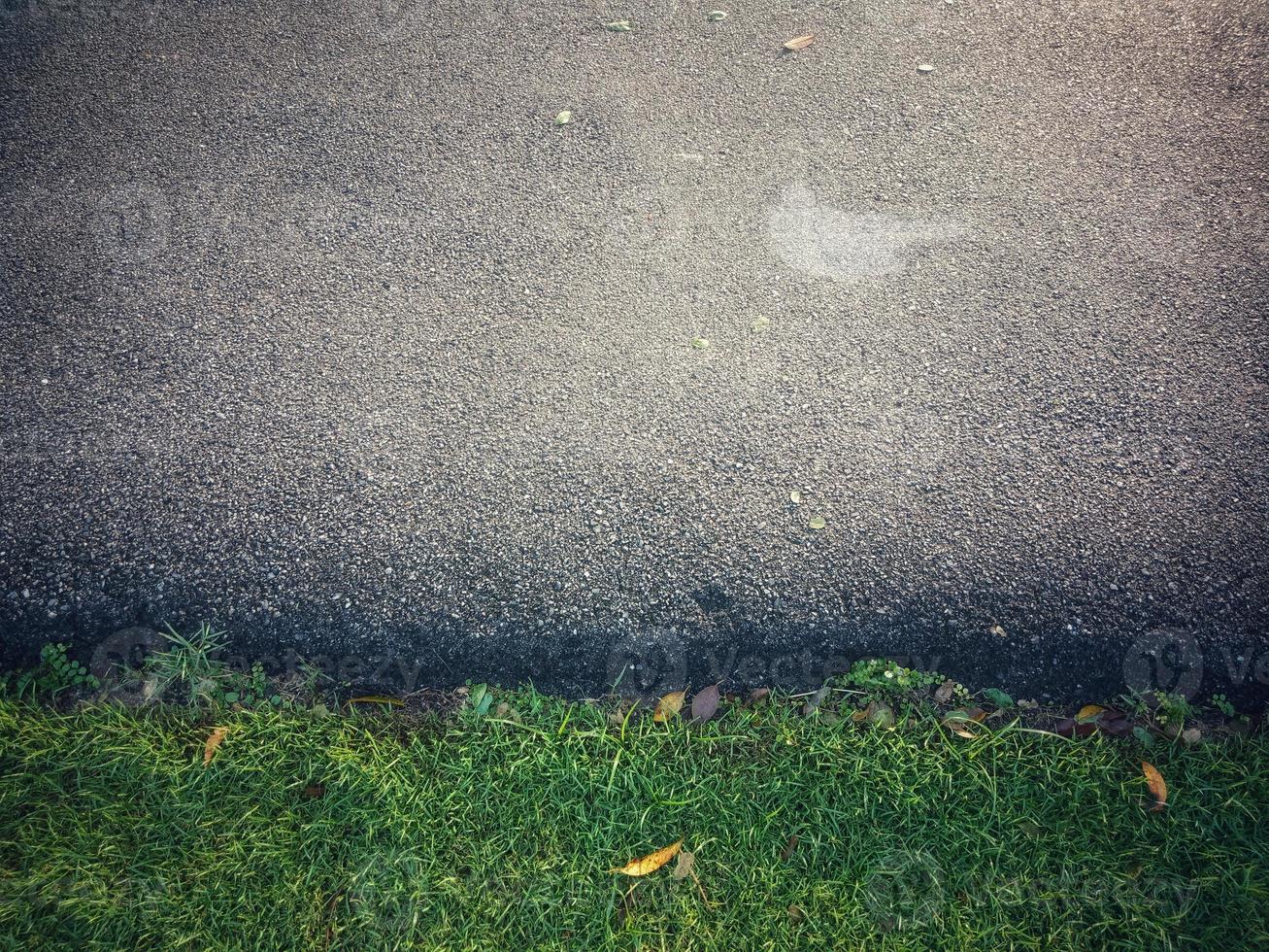 Road along the green lawn asphalt. photo