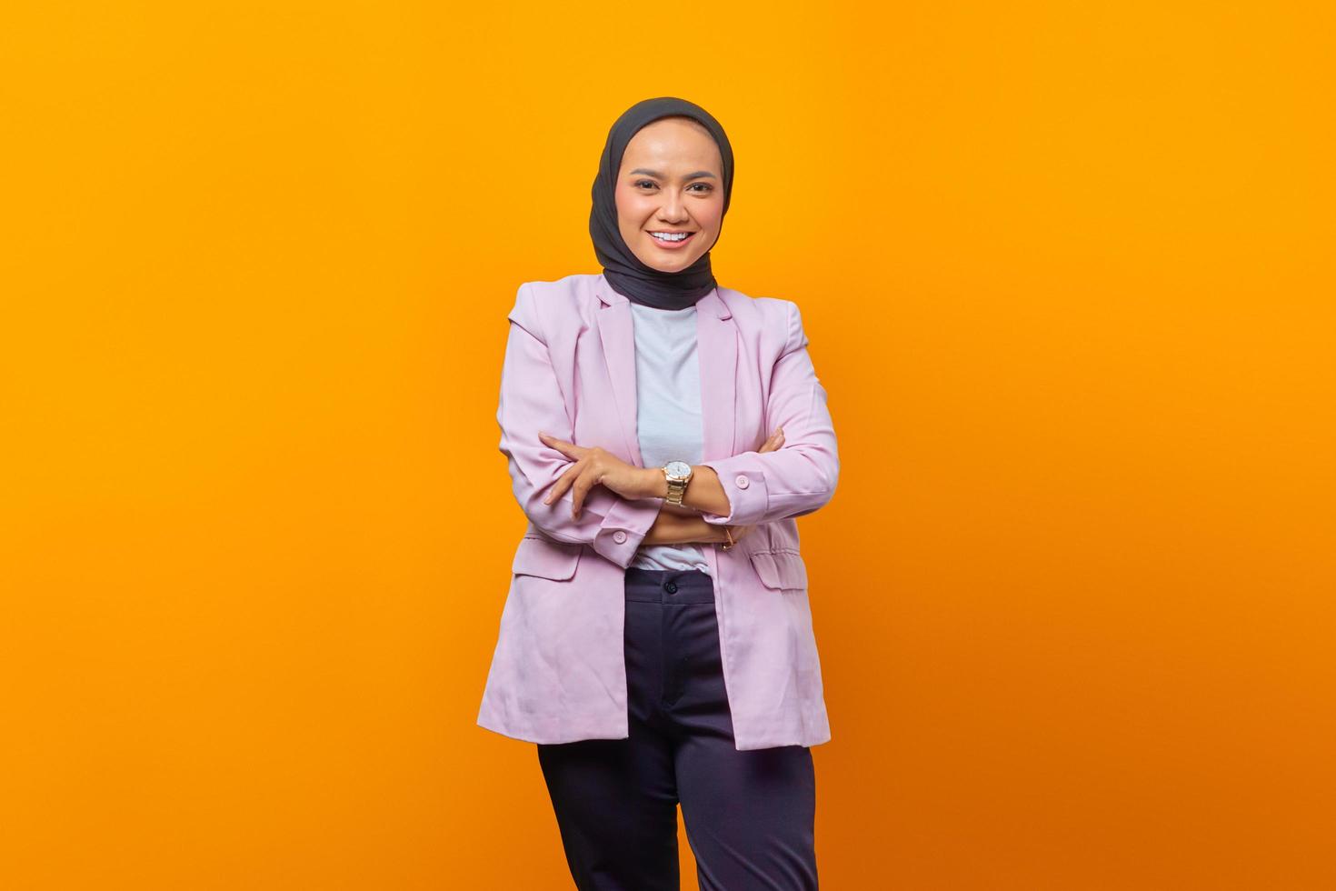 Cheerful Asian business woman crossing her arms in business suit photo