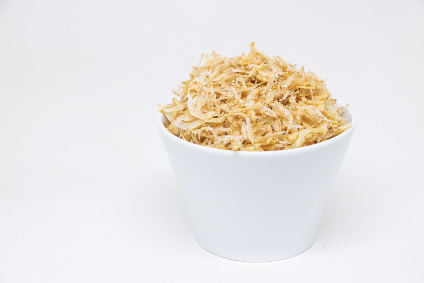 Dried shrimp in a white cup on a white background photo