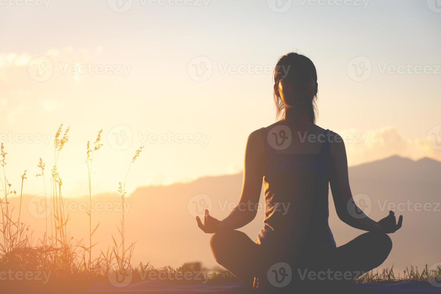 Silhouette of a woman doing yoga photo