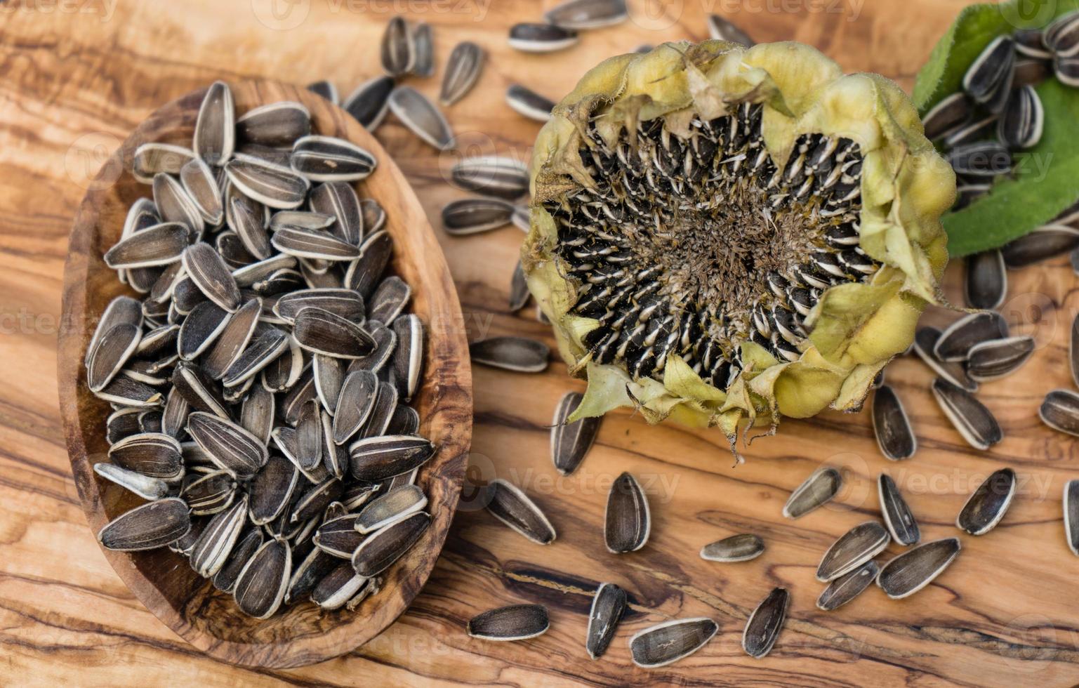 Sunflower seeds on olive wood photo