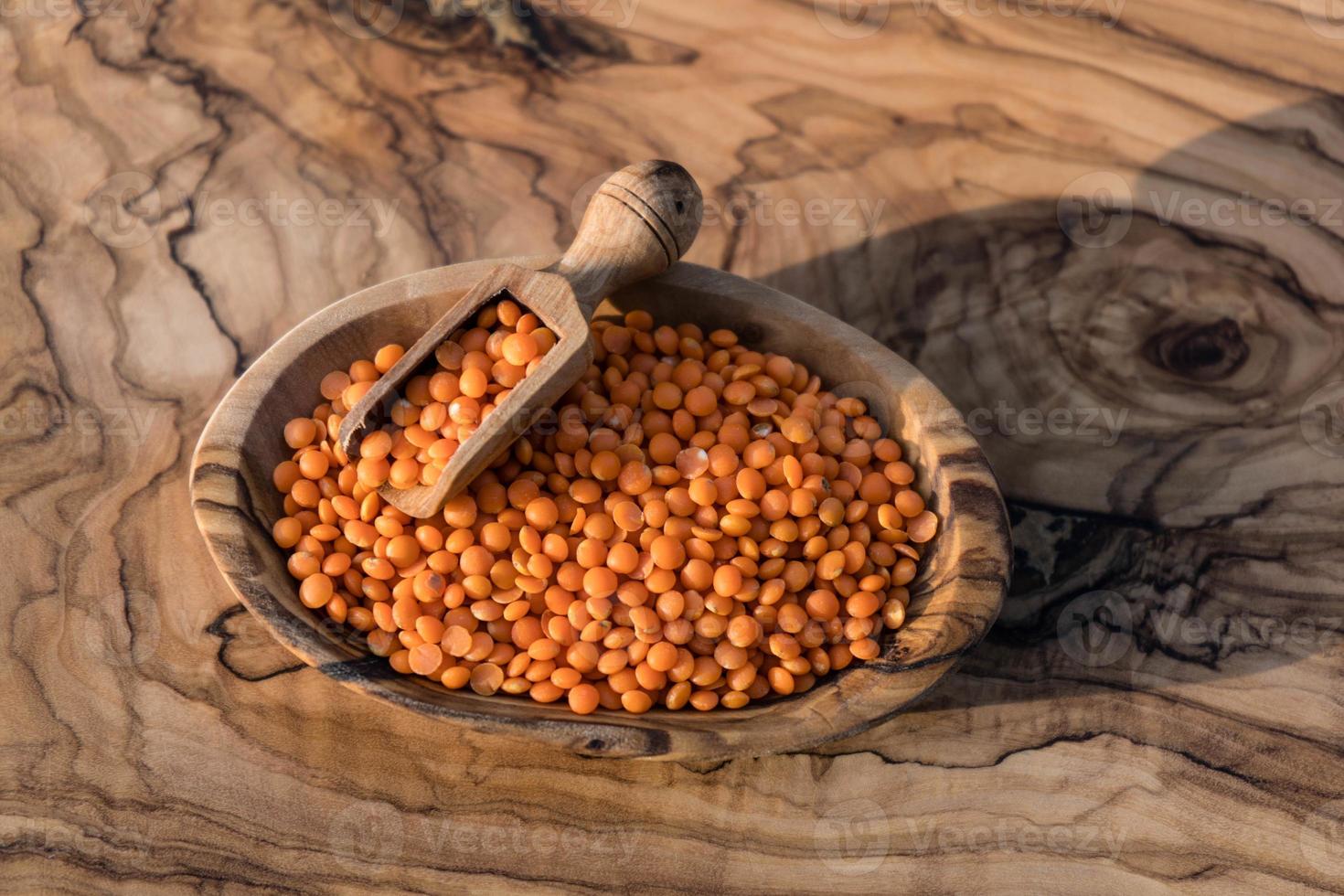 Red lentils on olive wood photo