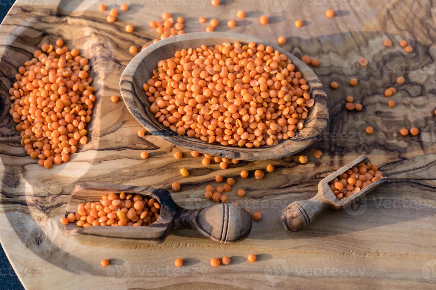 Red lentils on olive wood photo